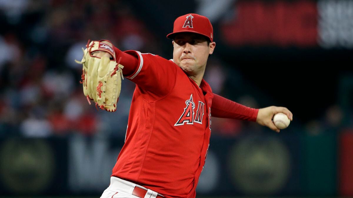 In this June 29, 2019, file photo, Los Angeles Angels starting pitcher Tyler Skaggs throws to the Oakland Athletics during a baseball game in Anaheim, Calif. Federal prosecutors say a former Angels employee has been charged with conspiracy to distribute fentanyl in connection with last year's overdose death of Angels pitcher Tyler Skaggs. Prosecutors in Texas say Eric Prescott Kay was arrested in Fort Worth, Texas, and made his first appearance Friday, Aug. 7, 2020, in federal court. Kay was communications director for the Angels.