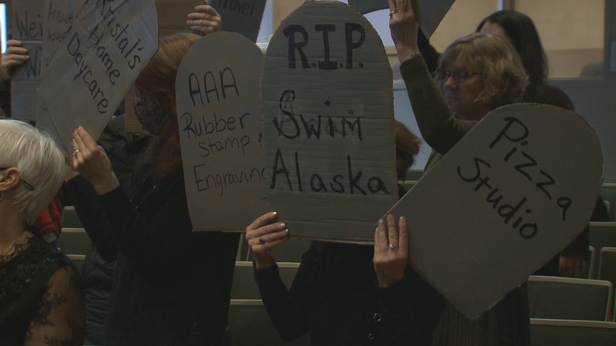 Anchorage small business owners held up cardboard tombstones in front of the Anchorage Assembly...