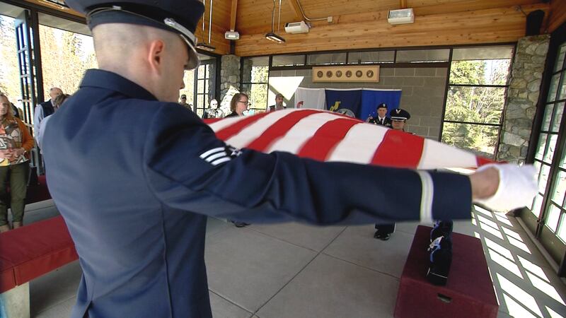 Service Members fold the ceremonial flag at an Unaccompanied Veterans Service at the Fort...