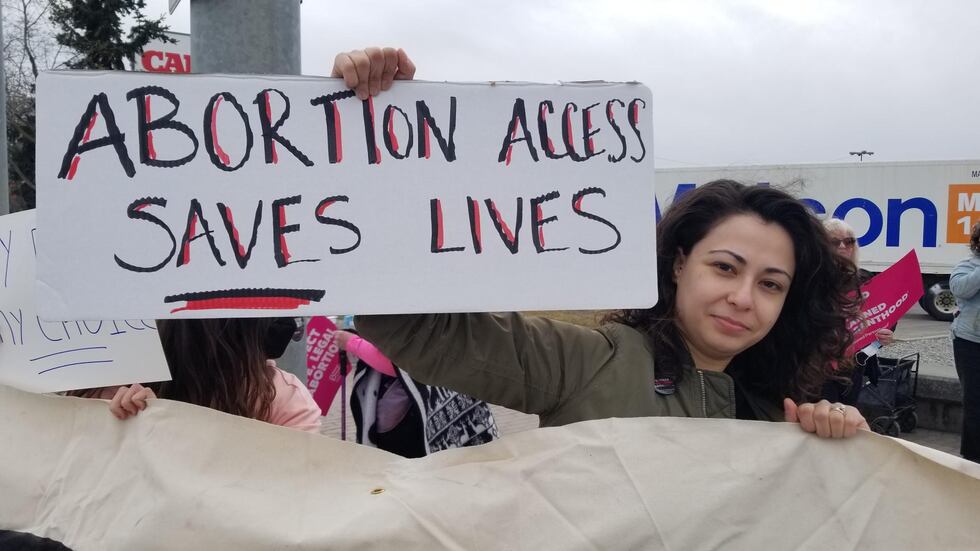 People gathered at the intersection of Northern Lights and Minnesota to protest the...