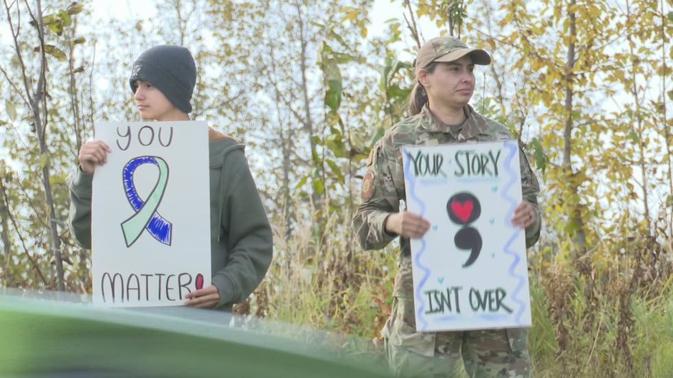 Volunteers gathered near the Boniface gates on JBER to wave signs of support for those...