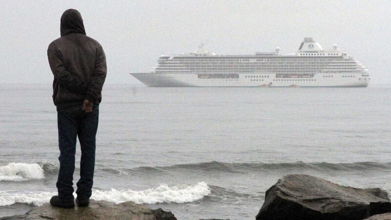 FILE - A man stands on the shore of the Bering Sea to watch the luxury cruise ship Crystal...