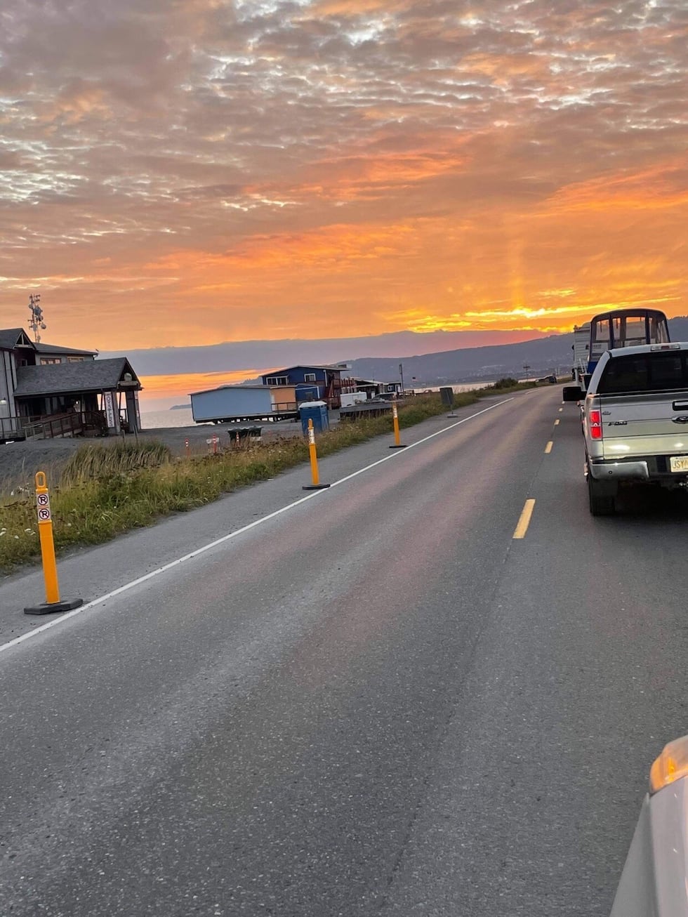 Cars evacuate off the Homer Spit after the community got a tsunami warning the evening of...