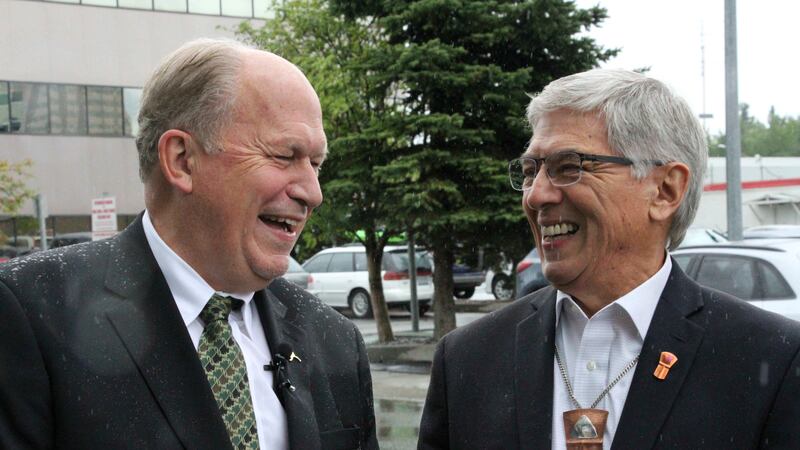Alaska Gov. Bill Walker, left, and Lt. Gov. Byron Mallott laugh at an outdoors news conference...