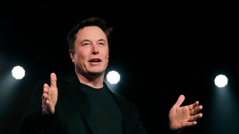 Tesla CEO Elon Musk speaks before unveiling the Model Y at Tesla's design studio in Hawthorne,...