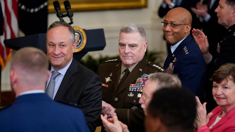 Chairman of the Joint Chiefs of Staff Gen. Mark Milley, center, second gentleman Doug Emhoff,...